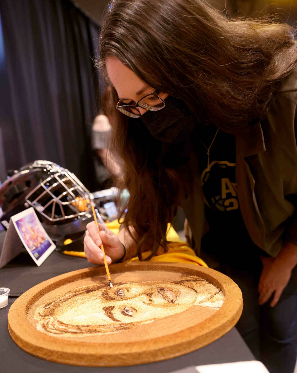 Jennifer Bush put finishing touches on a floragraph of her son Alexander during ...