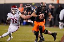 Oklahoma linebacker Nik Bonitto (11) is blocked by offensive lineman Cole Birmingham (67) as he ...