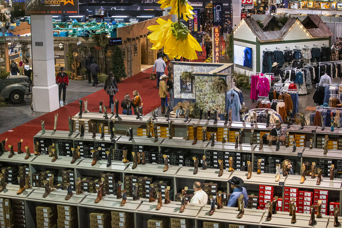 Shoppers wander about the merchandise on display during the opening night of the Cowboy Channel ...