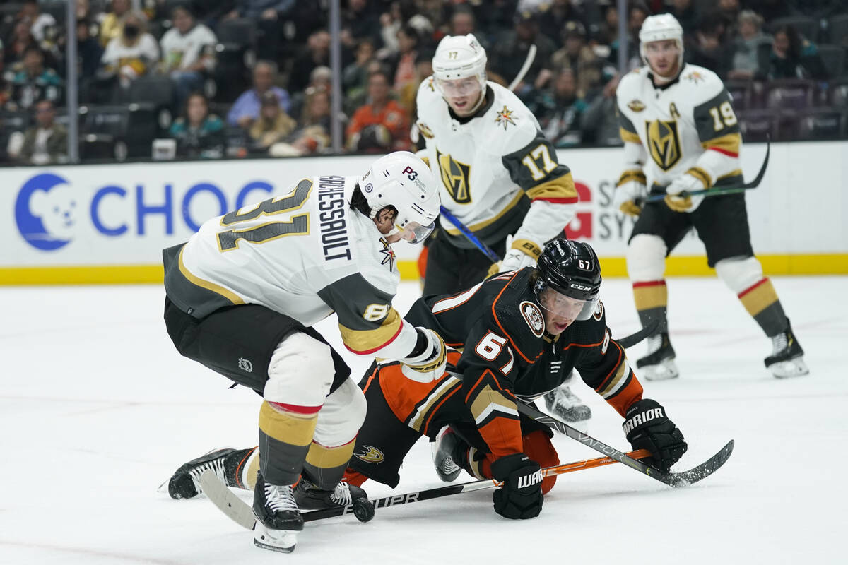 Anaheim Ducks' Rickard Rakell, right, fights for the puck with Vegas Golden Knights' Jonathan M ...