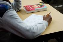 A sixth grade student writes down math problems during class at Democracy Prep in Las Vegas, Tu ...