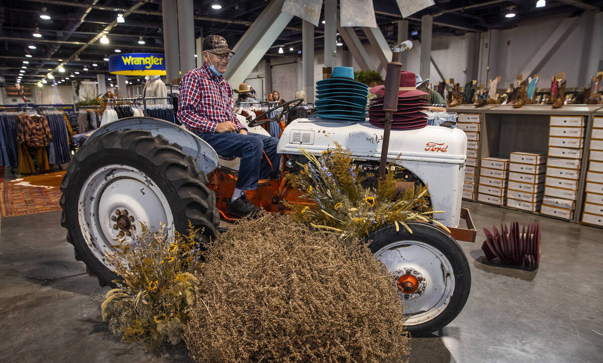 Larry Reed of Greensburgh, PA., sits on an old tractor as part of a display during the opening ...