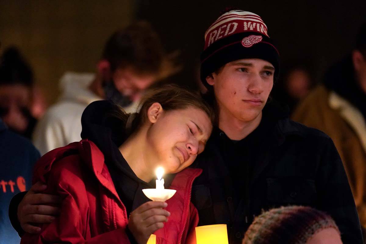 People attending a vigil embrace at LakePoint Community Church in Oxford, Mich., Tuesday, Nov. ...