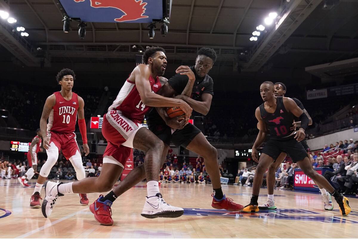 UNLV forward Royce Hamm Jr. (14) and SMU forward Jahmar Young Jr., center right, compete for co ...