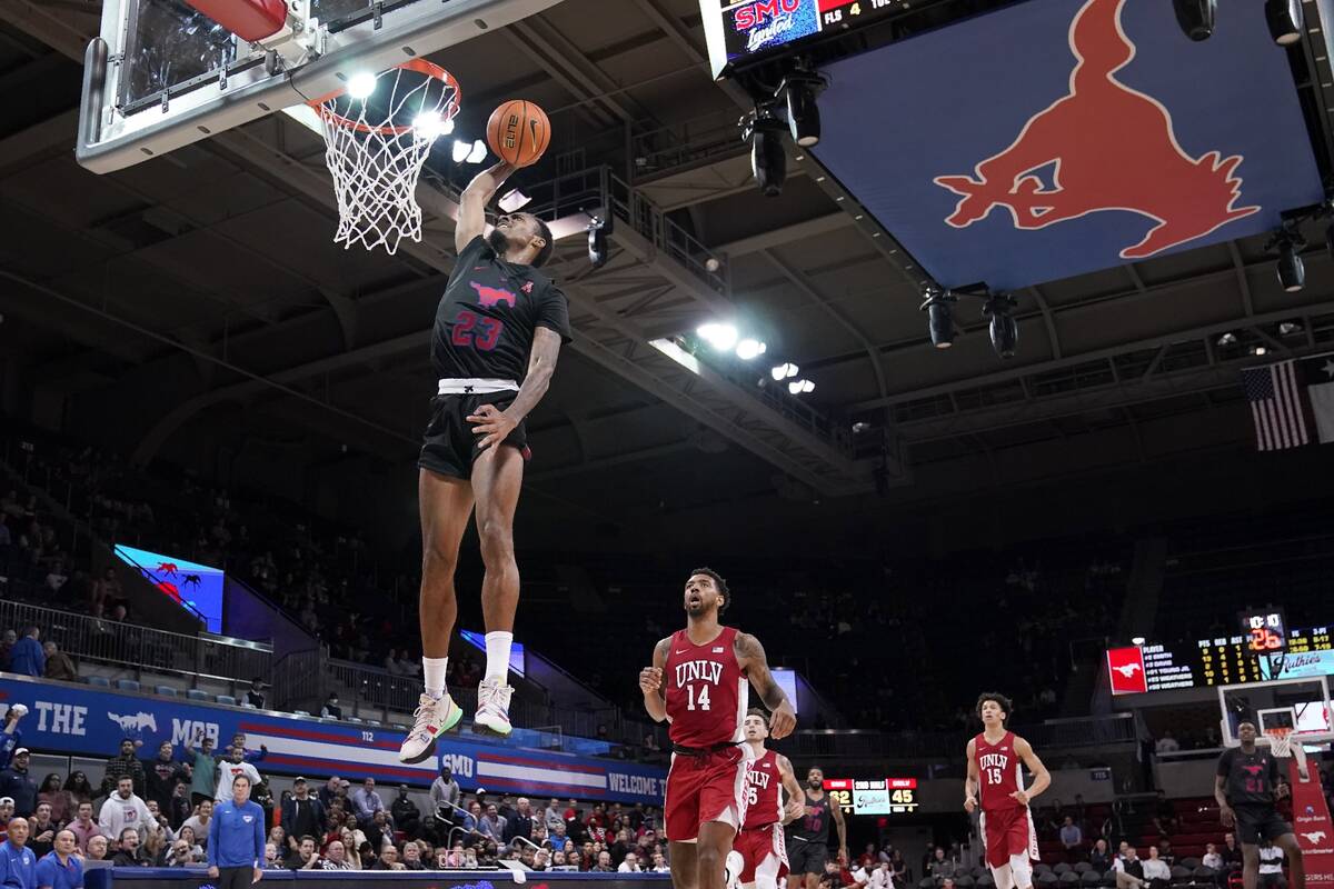 SMU guard Michael Weathers (23) leaps to the basket to dunk after getting past UNLV forward Roy ...