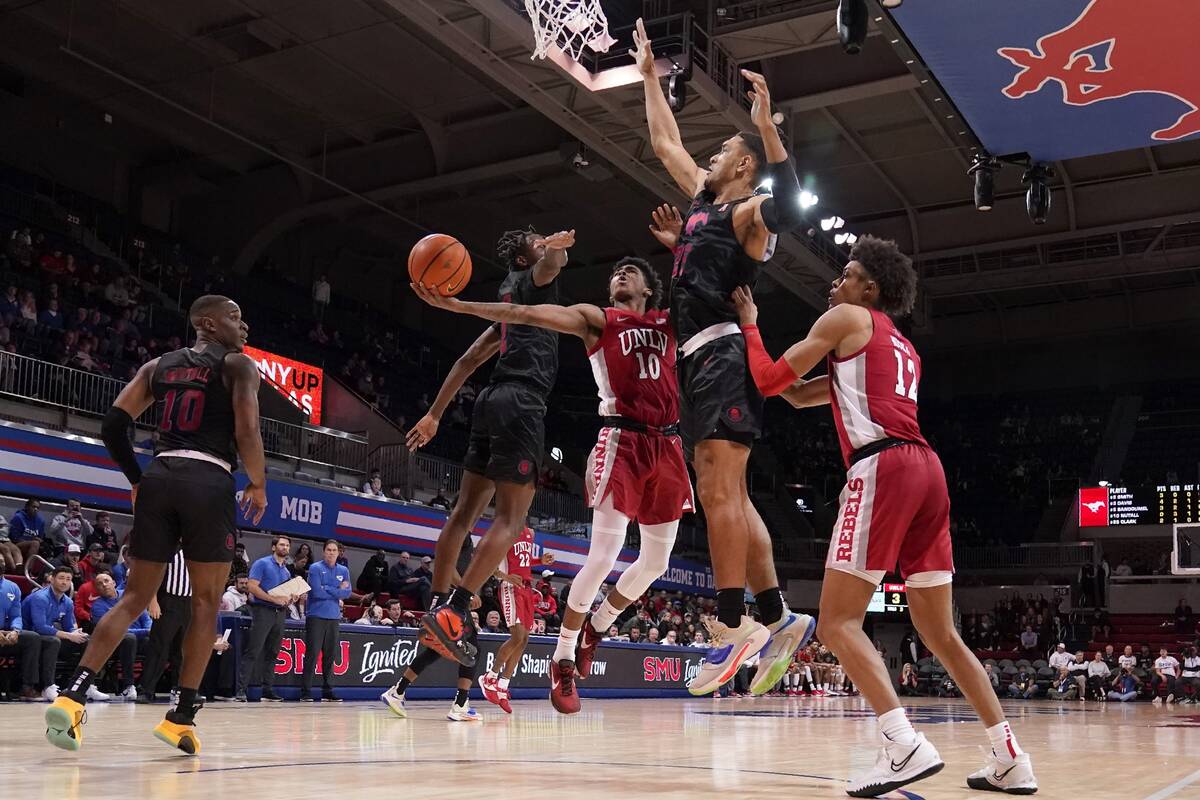 UNLV guard Keshon Gilbert (10) goes up for a shot between SMU's Jalen Smith (2) and Tristan Cla ...