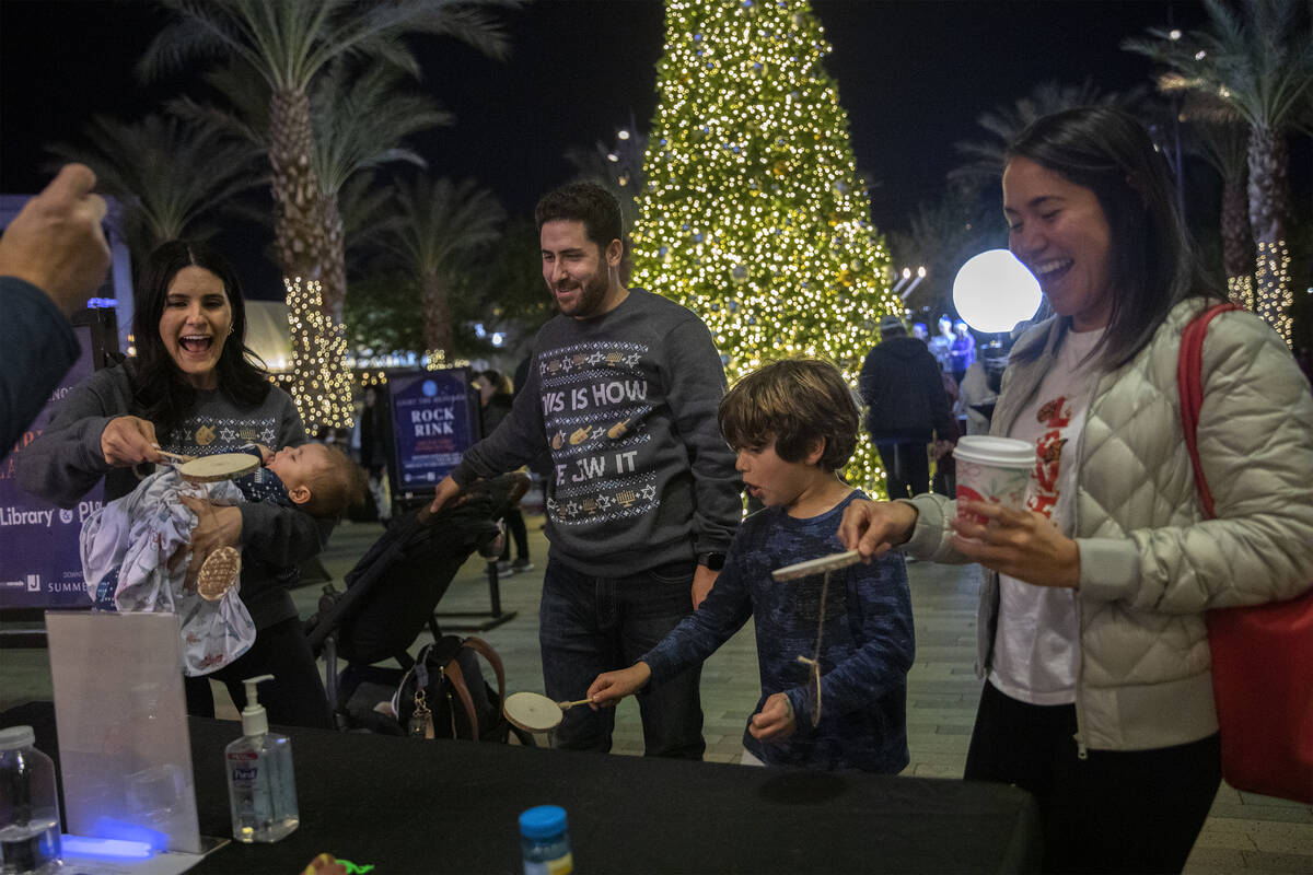 Sarah Weiser, left, Jeremy Weiser, Miles Bimbi, 7, and Yira Chacon, play a latke-flipping game ...