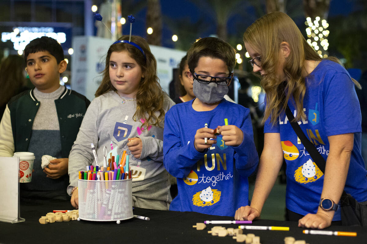 Gabriel Oles, second from right, 11, and his mother Kelly Oles, check out the dradel craft stat ...
