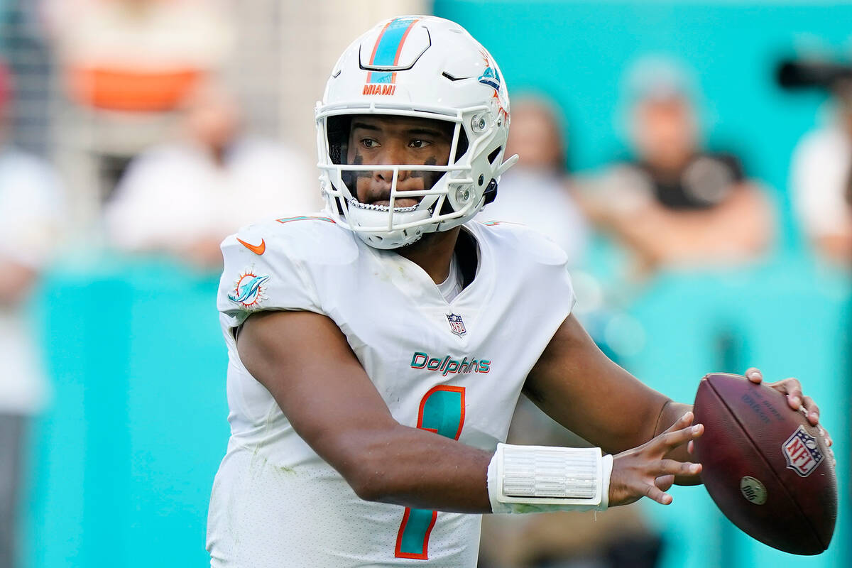 Miami Dolphins quarterback Tua Tagovailoa (1) aims a pass during the second half of an NFL foot ...