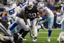 Raiders running back Josh Jacobs (28) leaps into the end zone in the first half during an NFL f ...