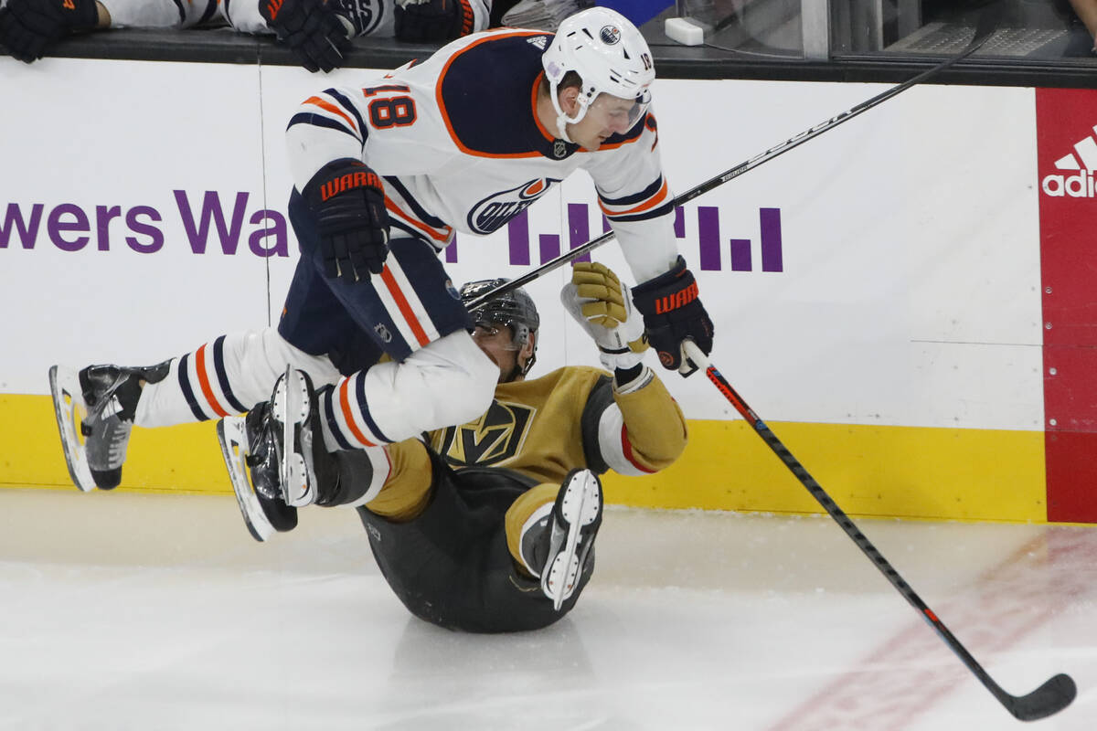 Edmonton Oilers left wing Zach Hyman (18) tangles with Golden Knights defenseman Shea Theodore ...