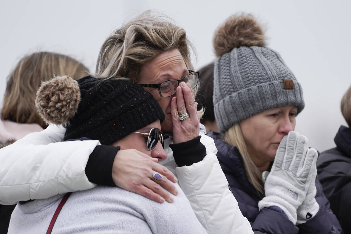 Mourners grieve at a memorial at Oxford High School in Oxford, Mich., Wednesday, Dec. 1, 2021. ...