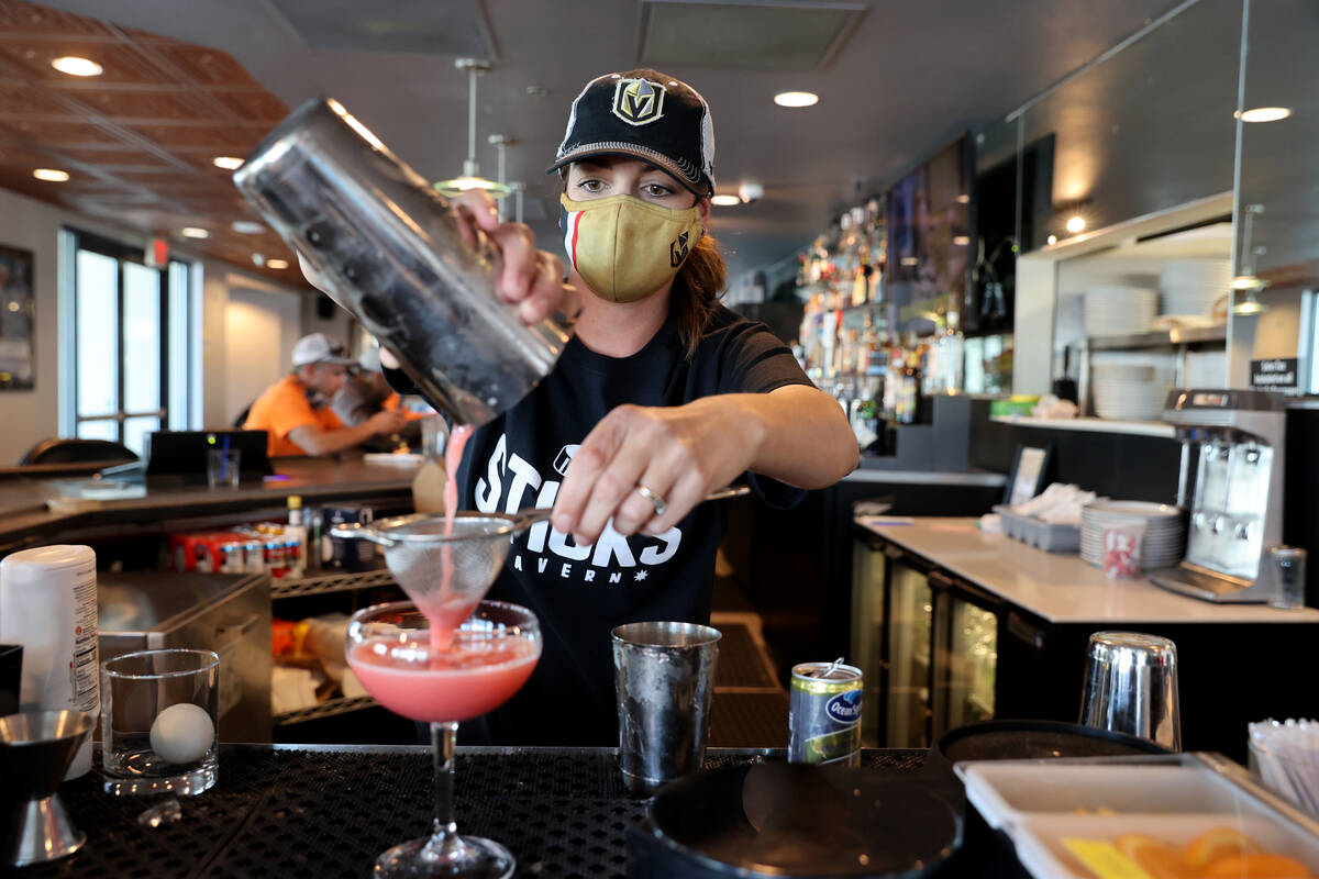 Bartender Virginia Douglass makes a Penalty Box with gin, strawberry, lemon and syrup at Sticks ...