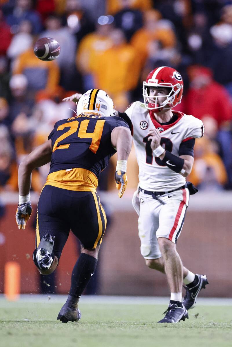 Georgia quarterback Stetson Bennett (13) throws to a receiver during the second half of an NCAA ...
