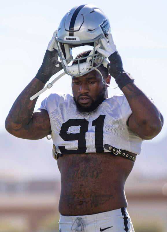 Raiders defensive end Yannick Ngakoue (91) puts his helmet on during practice at Raiders headqu ...