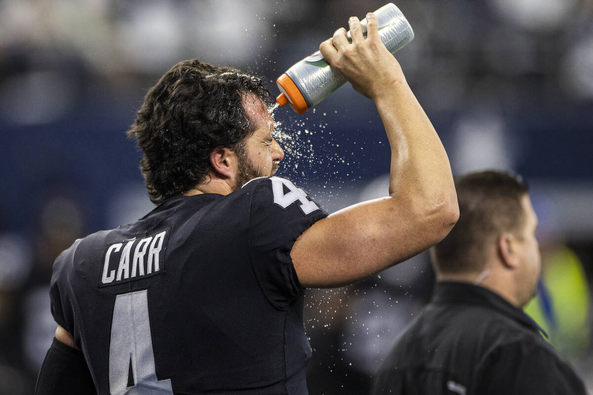Raiders quarterback Derek Carr (4) cools off during warm ups before the start of an NFL footbal ...