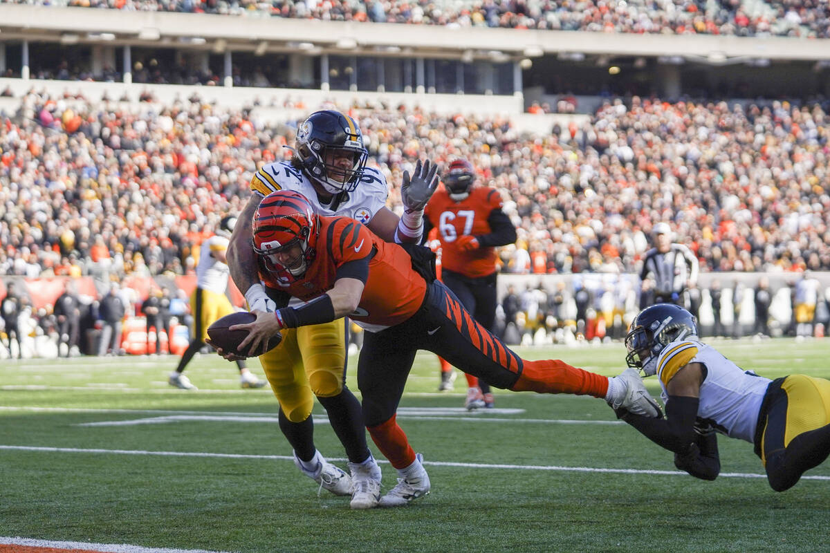 Cincinnati Bengals quarterback Joe Burrow (9) rushes into the end zone for a touchdown during a ...