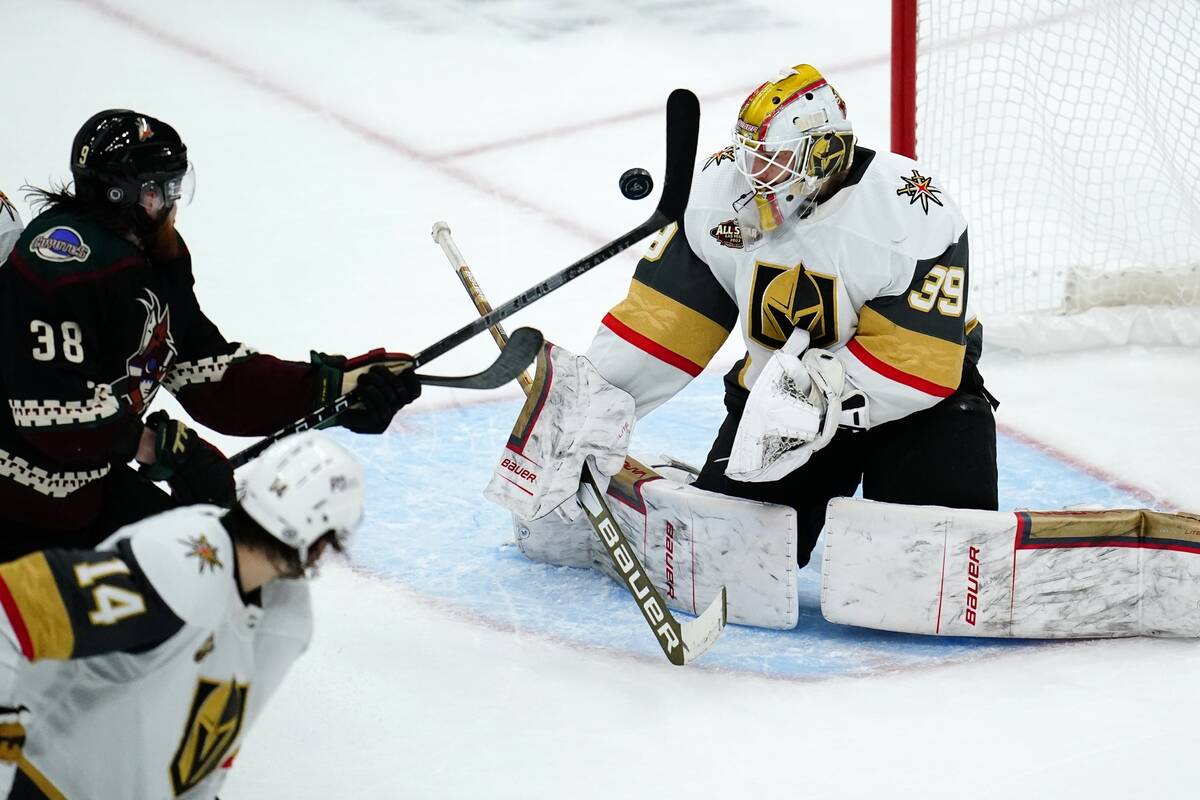 Vegas Golden Knights goalie Laurent Brossoit (39) makes a save on a shot as Arizona Coyotes cen ...