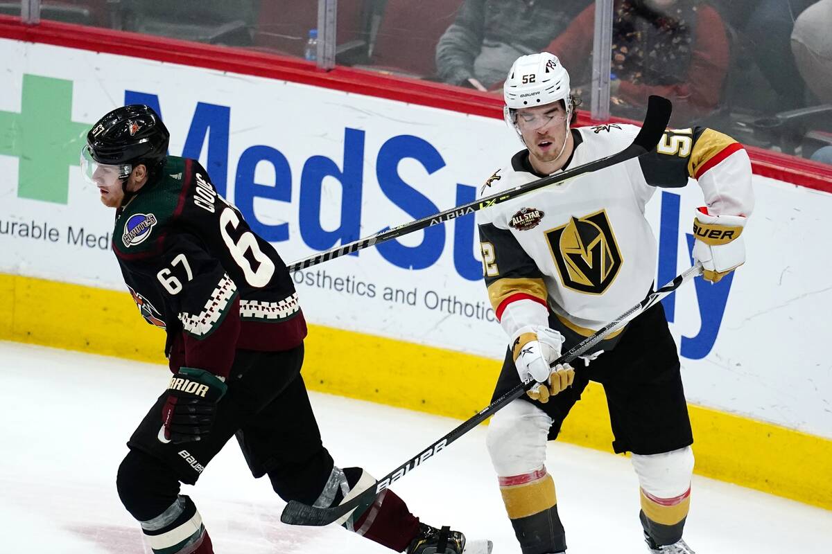 Arizona Coyotes left wing Lawson Crouse (67) catches Vegas Golden Knights defenseman Dylan Cogh ...