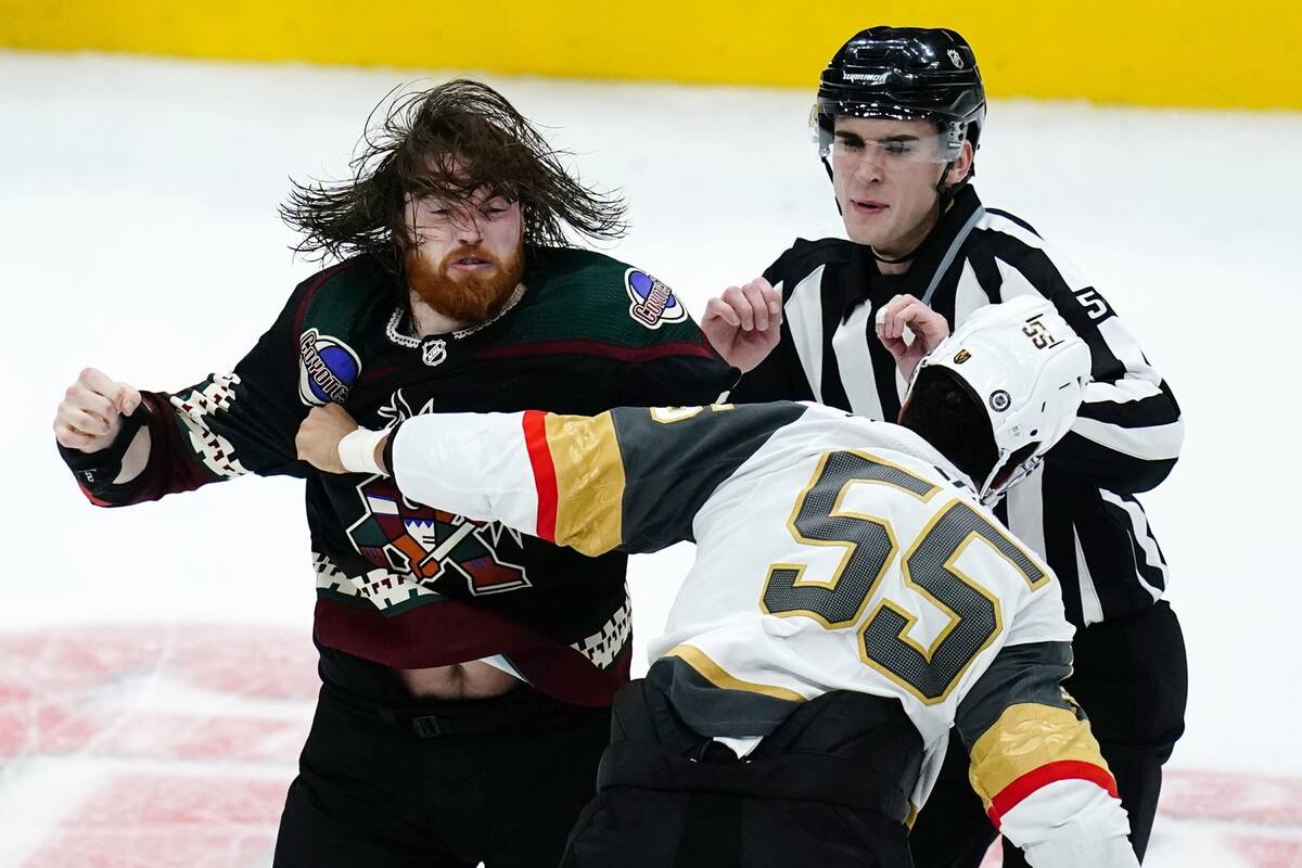 Vegas Golden Knights right wing Keegan Kolesar (55) fights with Arizona Coyotes center Liam O'B ...