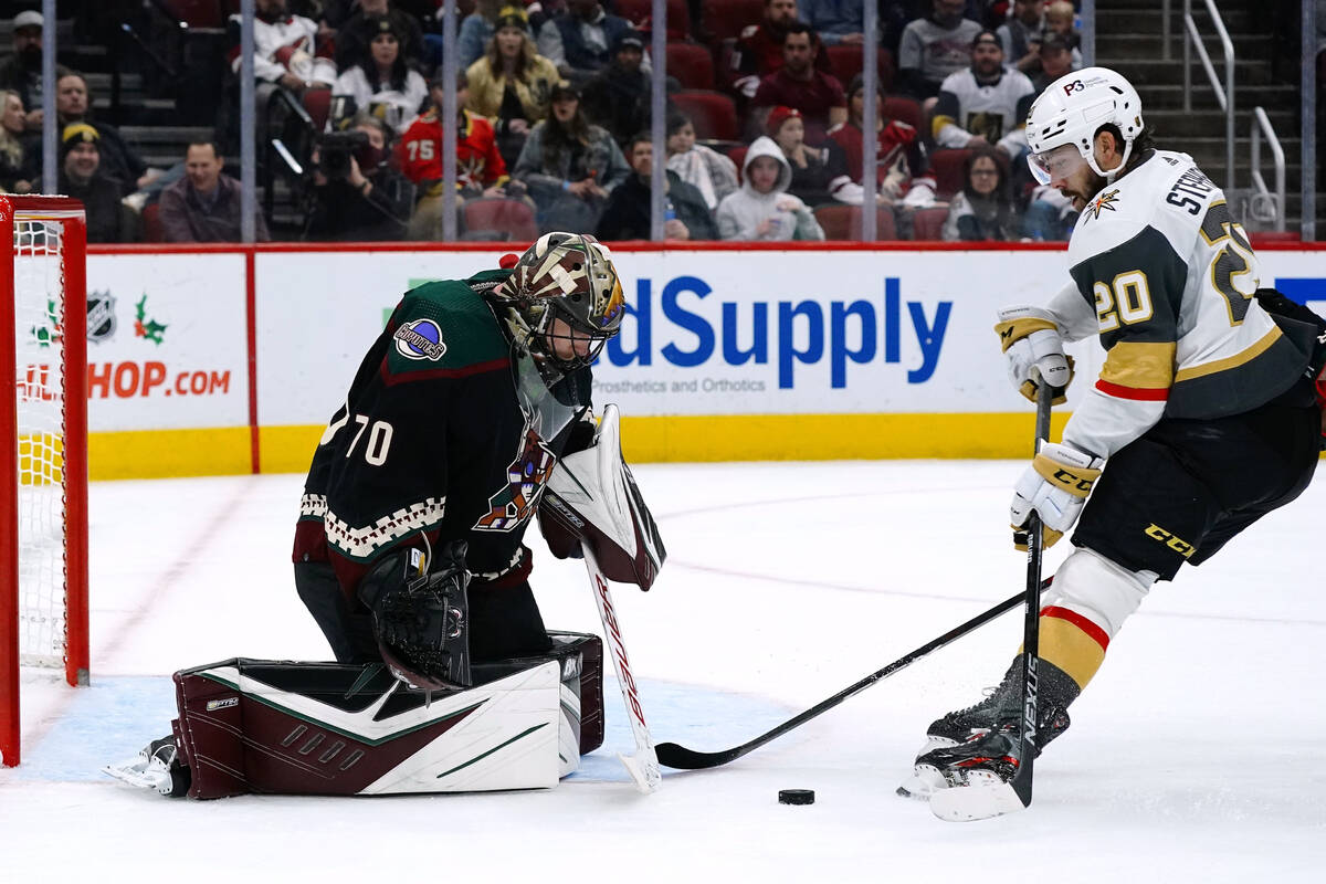 Arizona Coyotes goaltender Karel Vejmelka (70) makes a save on Vegas Golden Knights center Chan ...