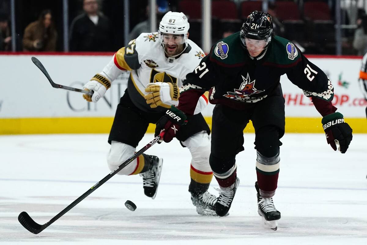 Arizona Coyotes left wing Loui Eriksson (21) keeps the puck away from Vegas Golden Knights left ...