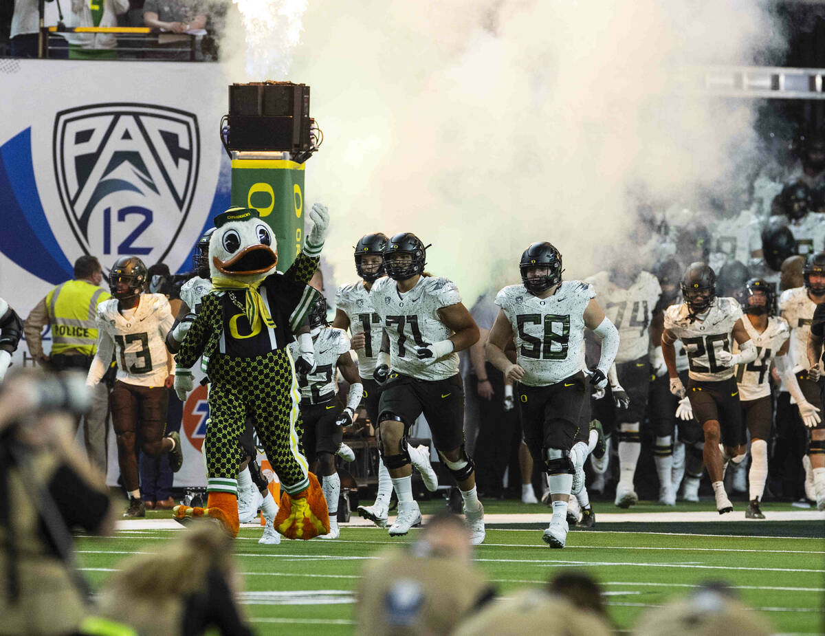 Oregon Ducks players take the field to face Utah Utes during the first half of the Pac-12 champ ...