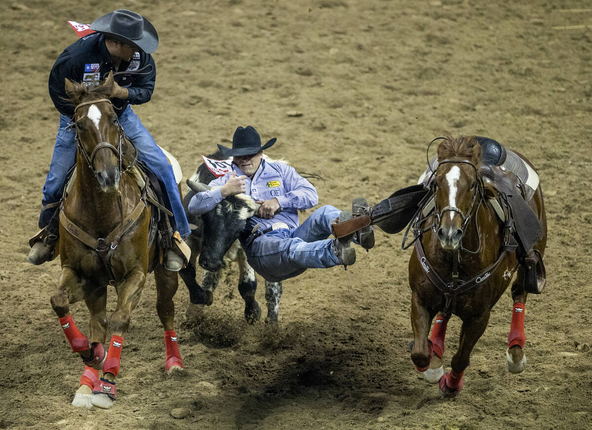 Tristan Martin of Sulphur, Louisiana, grabs his animal in Steer Wrestling for first place durin ...