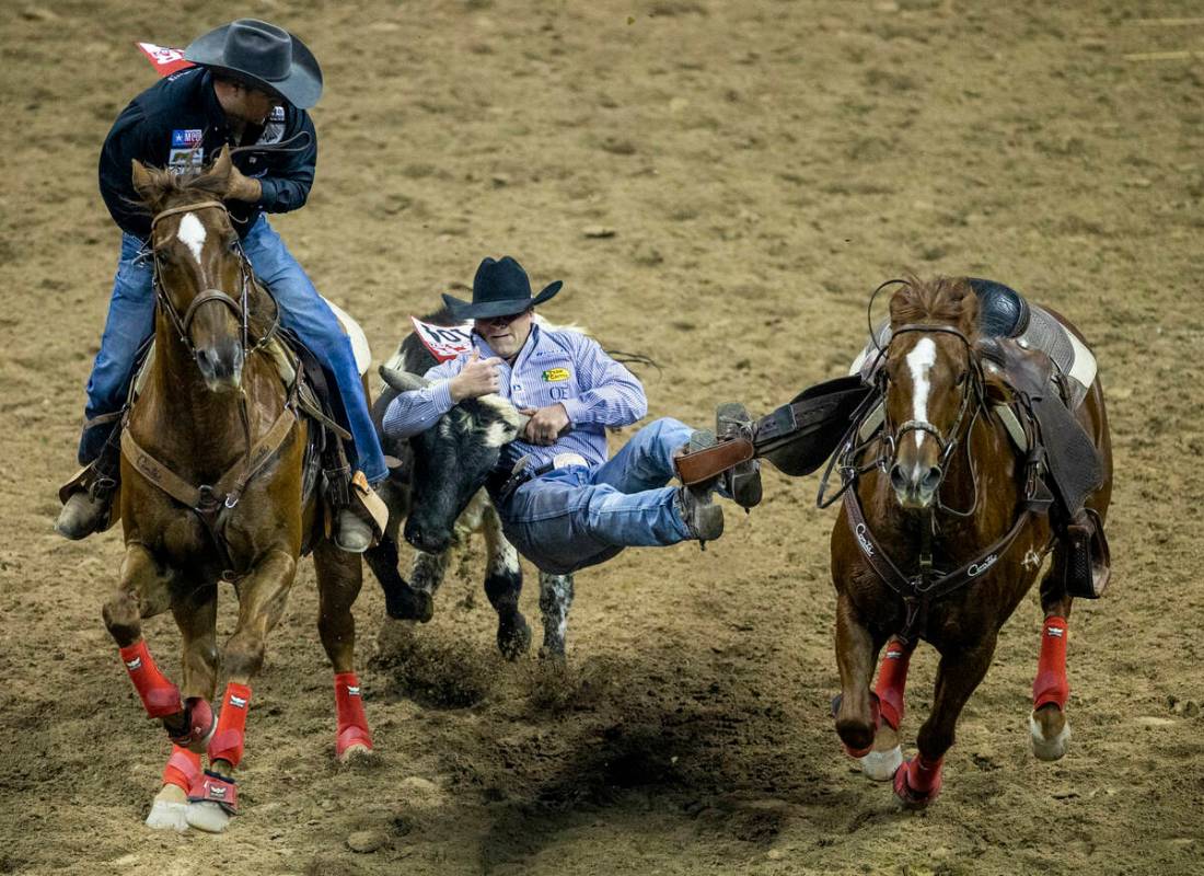 Tristan Martin of Sulphur, Louisiana, grabs his animal in Steer Wrestling for first place durin ...