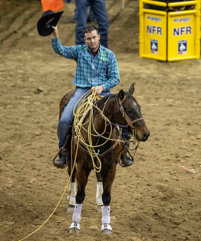 Caleb Smidt of Bellville, Texas, thanks the fans after taking first place in Tie-Down Roping du ...
