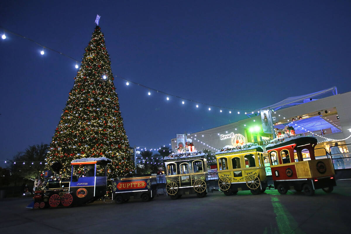 Jupiter Express Holiday Train engineer Chelita Mendoza, left, drives a train at Downtown Summer ...