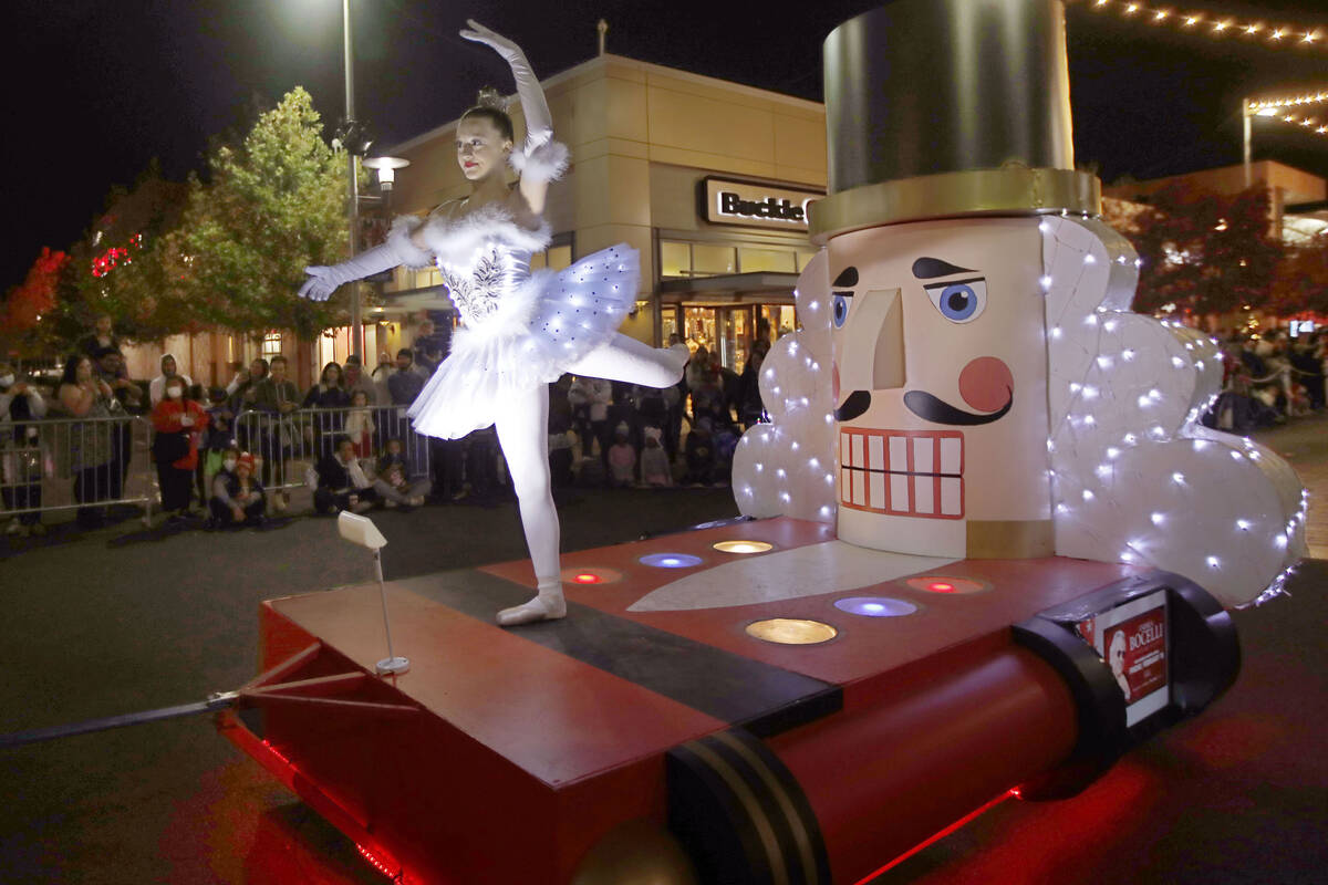 A dancer performs on a Nutcracker-inspired float during a holiday parade at Downtown Summerlin, ...