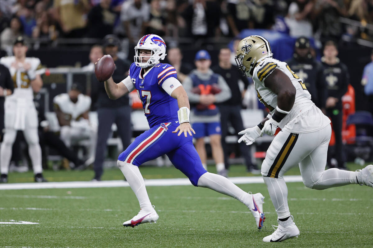 Buffalo Bills quarterback Josh Allen (17) scrambles from New Orleans Saints defensive tackle Jo ...