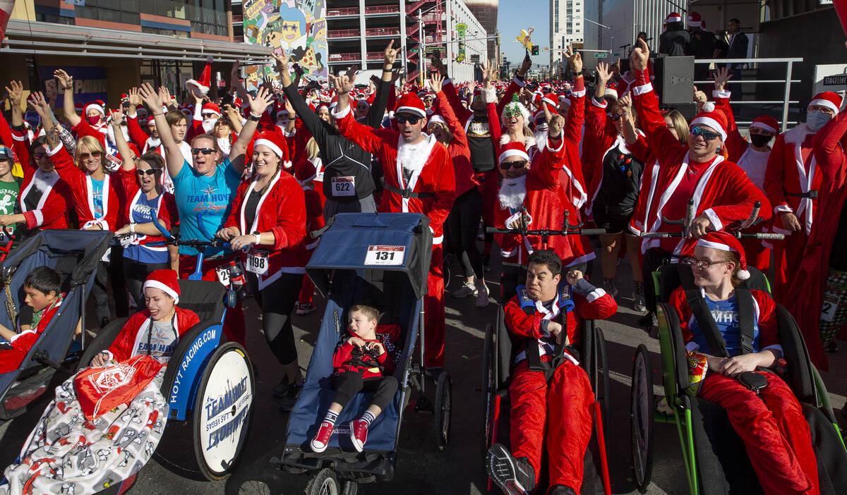 Runners cheer before the race starts during The Las Vegas Great Santa Run on Saturday, Dec. 4, ...