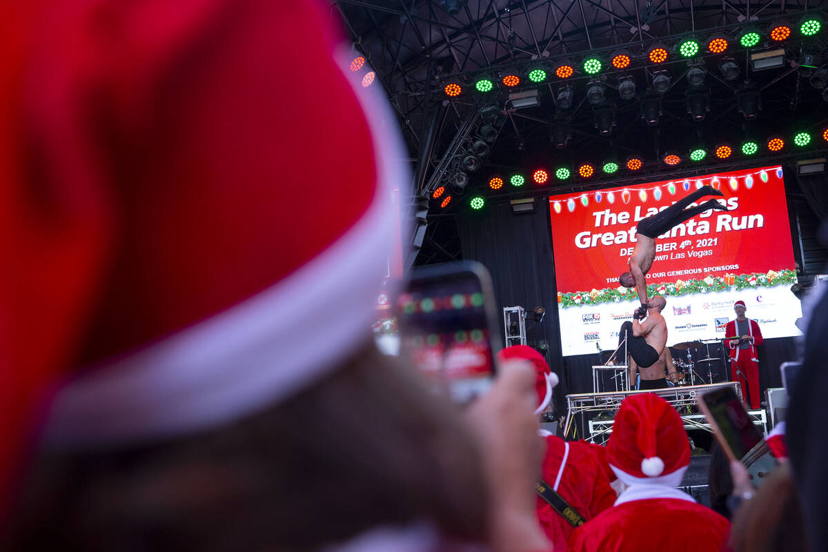 Acrobats perform at Fremont Street Experience during The Las Vegas Great Santa Run on Saturday, ...