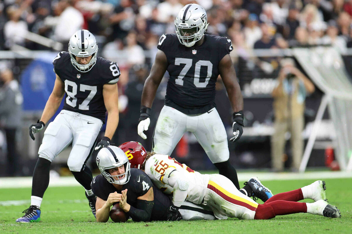 Raiders quarterback Derek Carr (4) calls a timeout after getting tackled by Washington Football ...