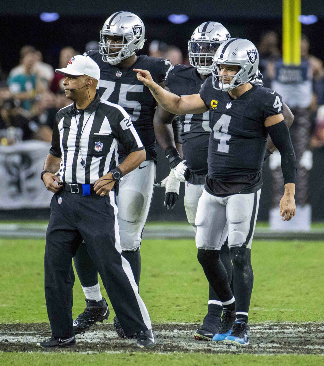 Raiders quarterback Derek Carr (4) pleads his case for a late hit from the Washington Football ...