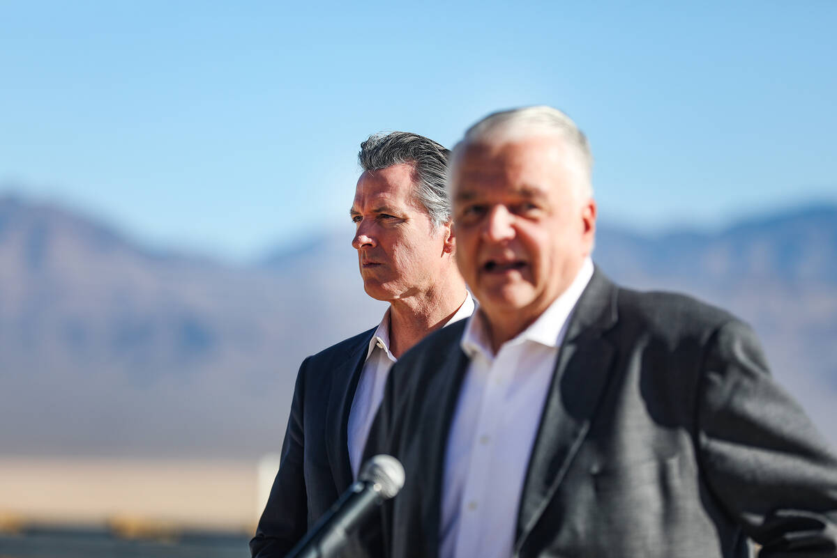 California Gov. Gavin Newsom looks as Nevada Gov. Steve Sisolak addresses the media at a press ...