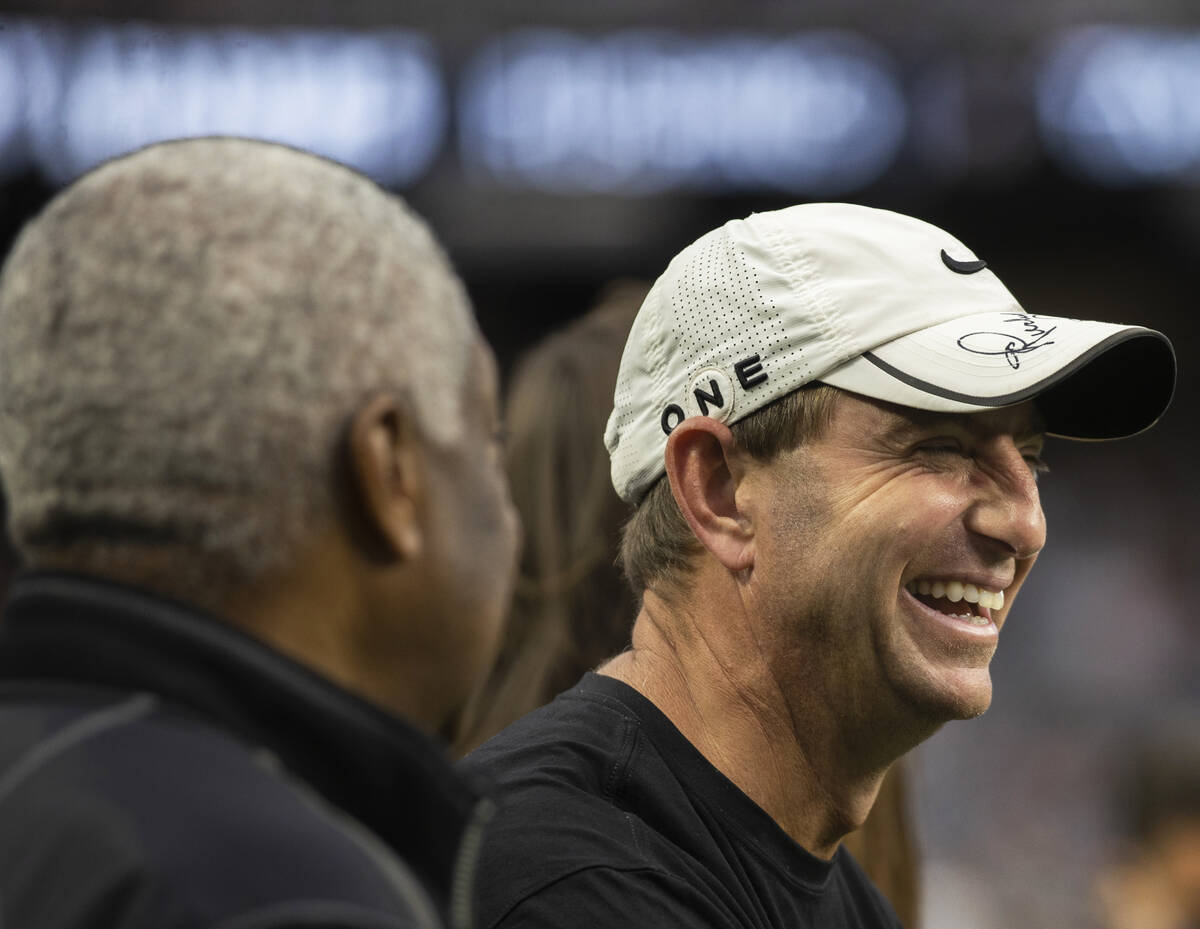 Clemson head football coach Dabo Swinney, right, watches an NFL football game between the Raide ...