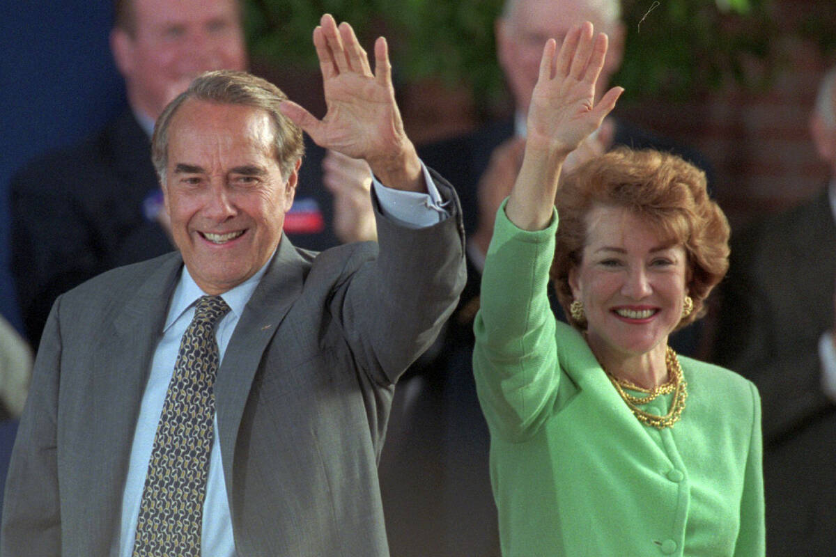 FILE - Republican presidential nominee Bob Dole and his wife Elizabeth wave to well-wishers at ...