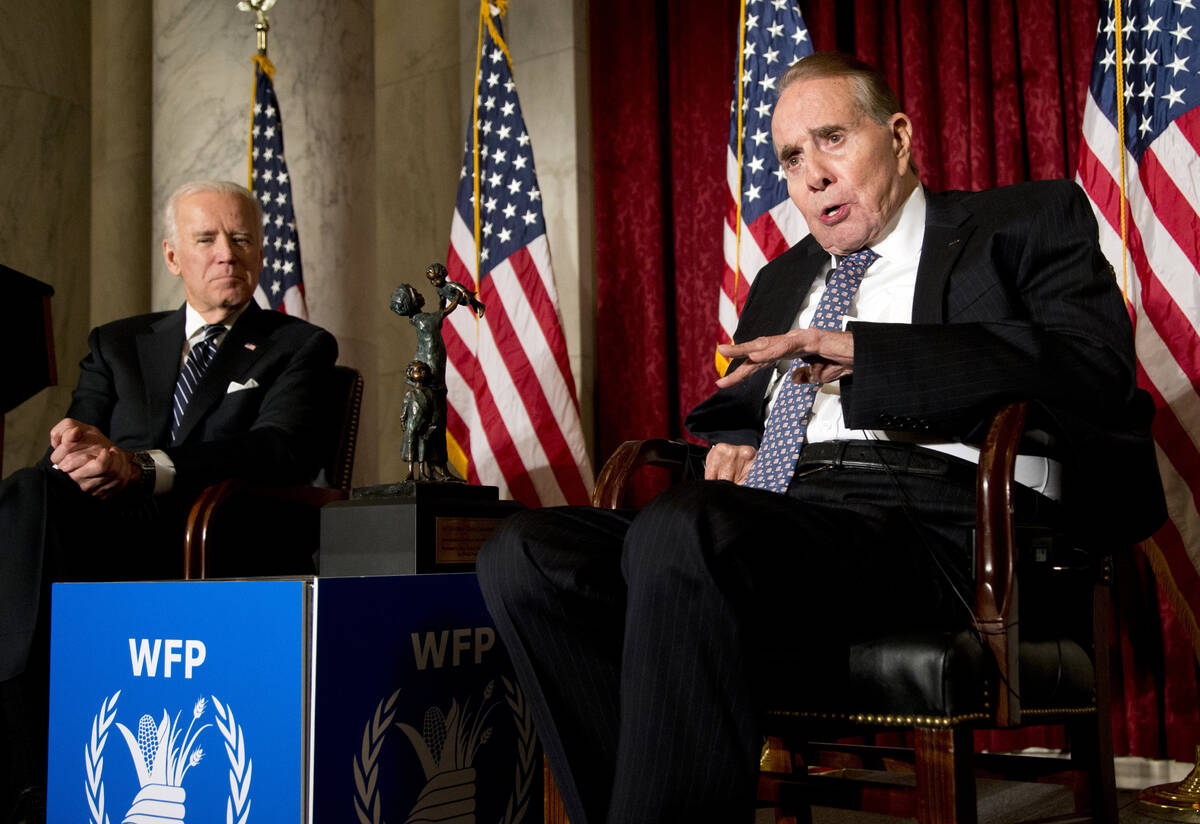 FILE - Former Senate Majority Leader Bob Dole, right, speaks after being presented with the McG ...