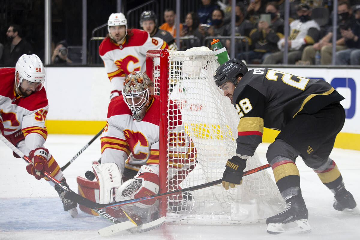 Vegas Golden Knights left wing William Carrier takes a shot on Calgary Flames goaltender Jacob ...