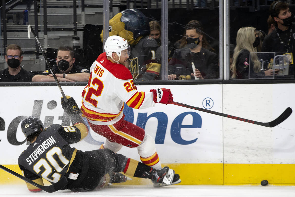 Vegas Golden Knights center Michael Amadio (22) collides with Calgary Flames center Trevor Lewi ...