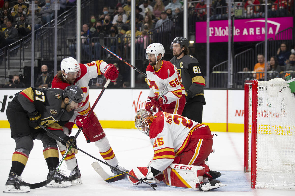 Calgary Flames goaltender Jacob Markstrom (25) saves a shot on goal by Vegas Golden Knights lef ...