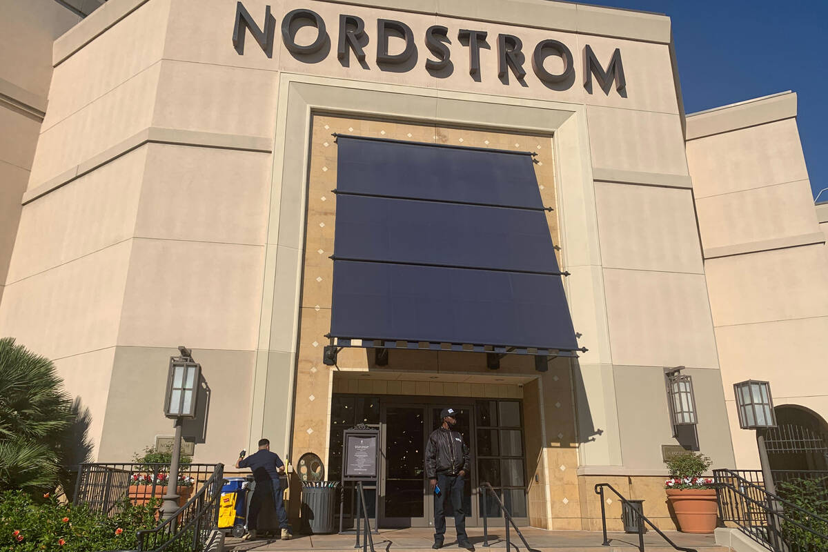 A security guard stands outside the Nordstrom store at The Grove