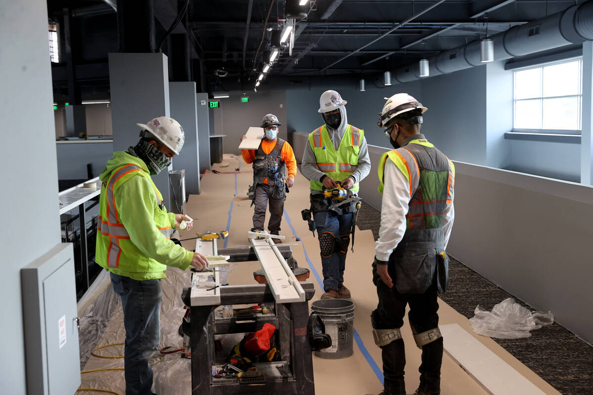 Workers on the Royal Landing premium level at the Dollar Loan Center is shown during a tour of ...