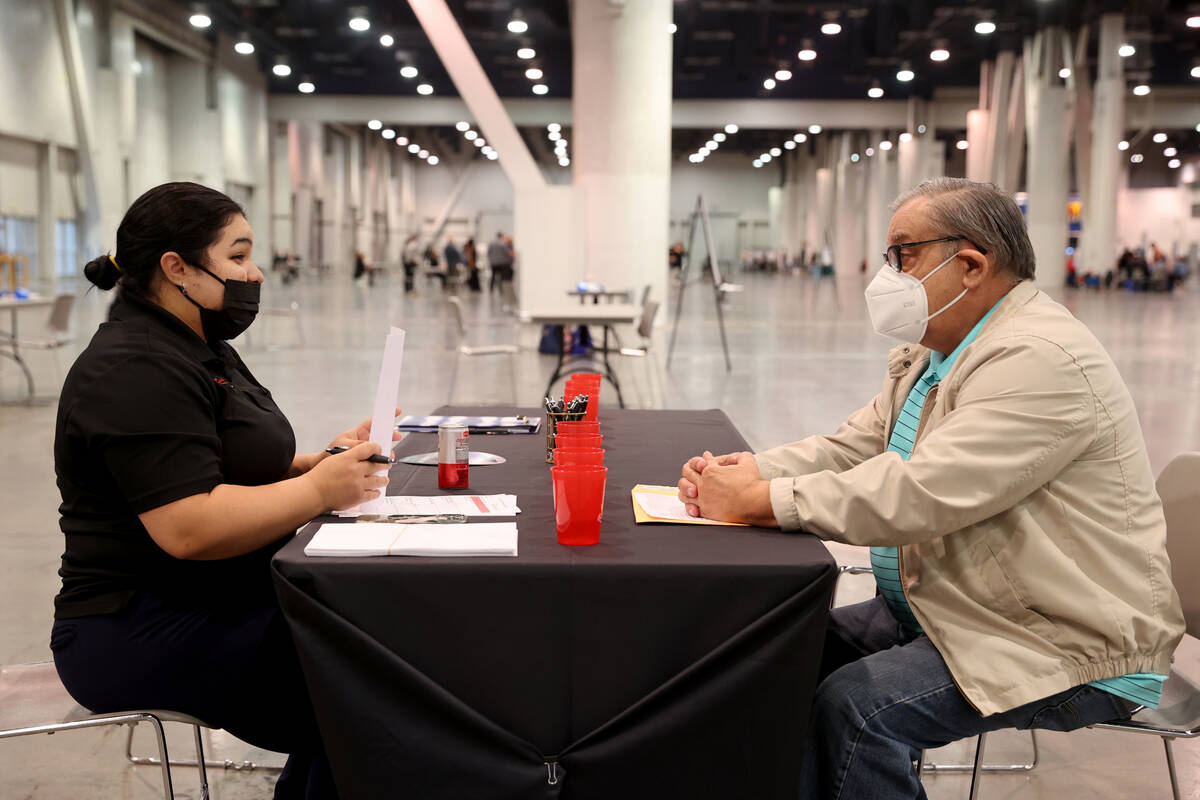Job seeker Donald Tobin of Las Vegas interviews with Alianet Gonzalez of Resorts World during J ...