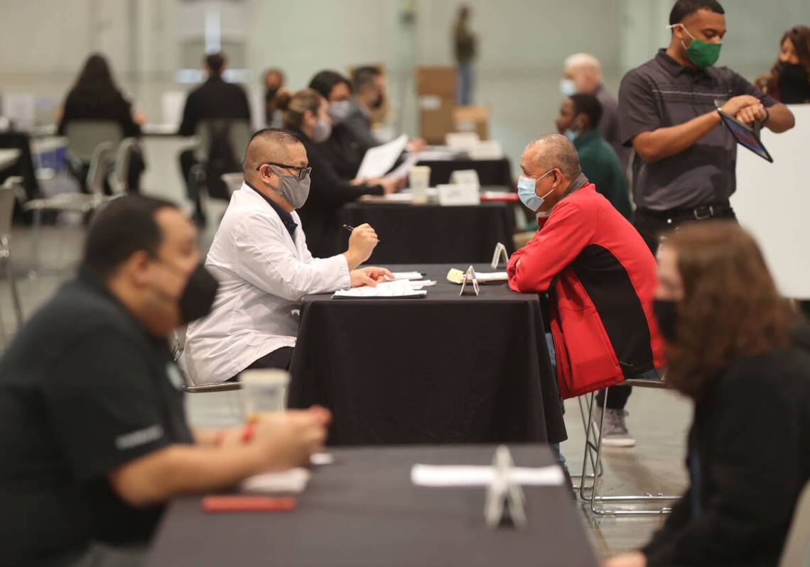 Job seeker Mark Madaran, center left, senior executive assistant for stewards at MGM, interview ...