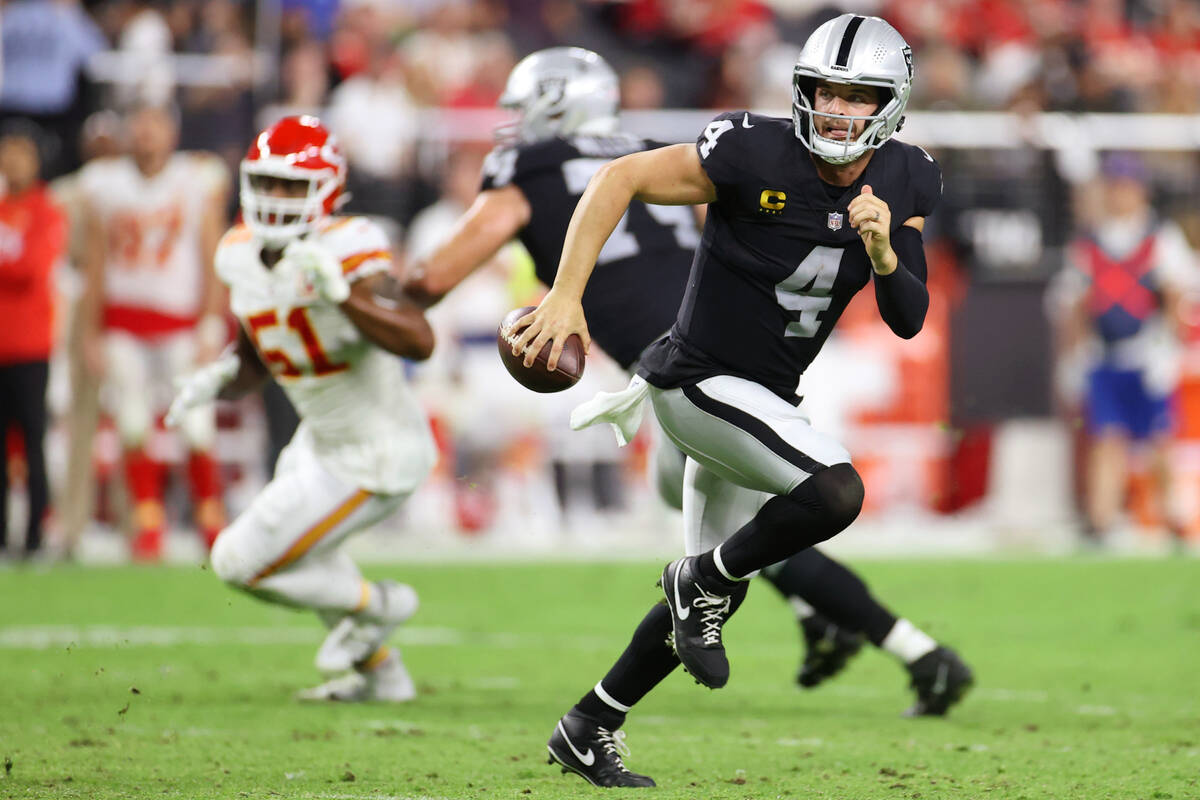 Raiders quarterback Derek Carr (4) looks for an open pass against the Kansas City Chiefs during ...