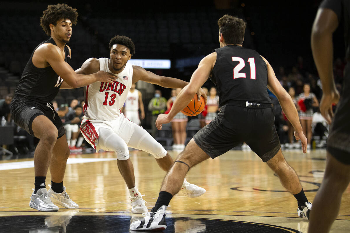 UNLV Rebels guard Bryce Hamilton (13) drives around Seattle Redhawks guard Riley Grigsby (11) a ...